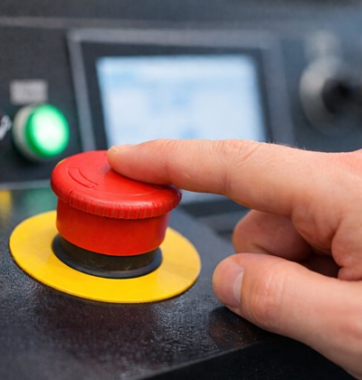 Finger on the emergency stop button