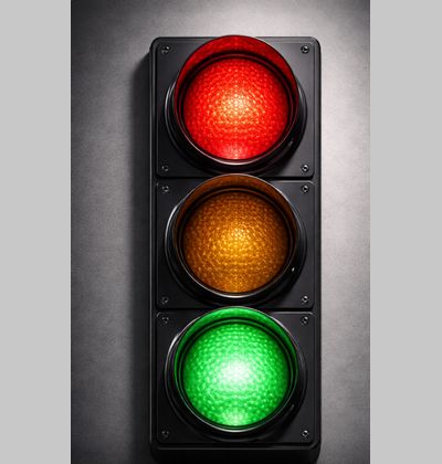A traffic light with both the green and red lights on